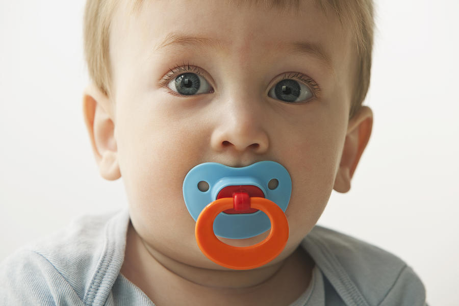 Mixed race baby boy sucking pacifier #1 Photograph by Jose Luis Pelaez Inc