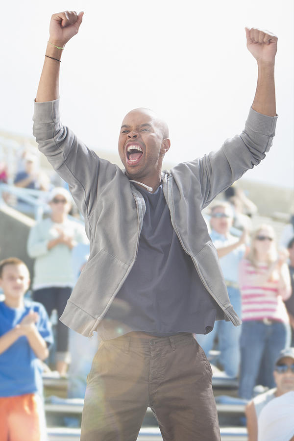 Mixed race man cheering at sporting event #1 Photograph by Jose Luis Pelaez Inc