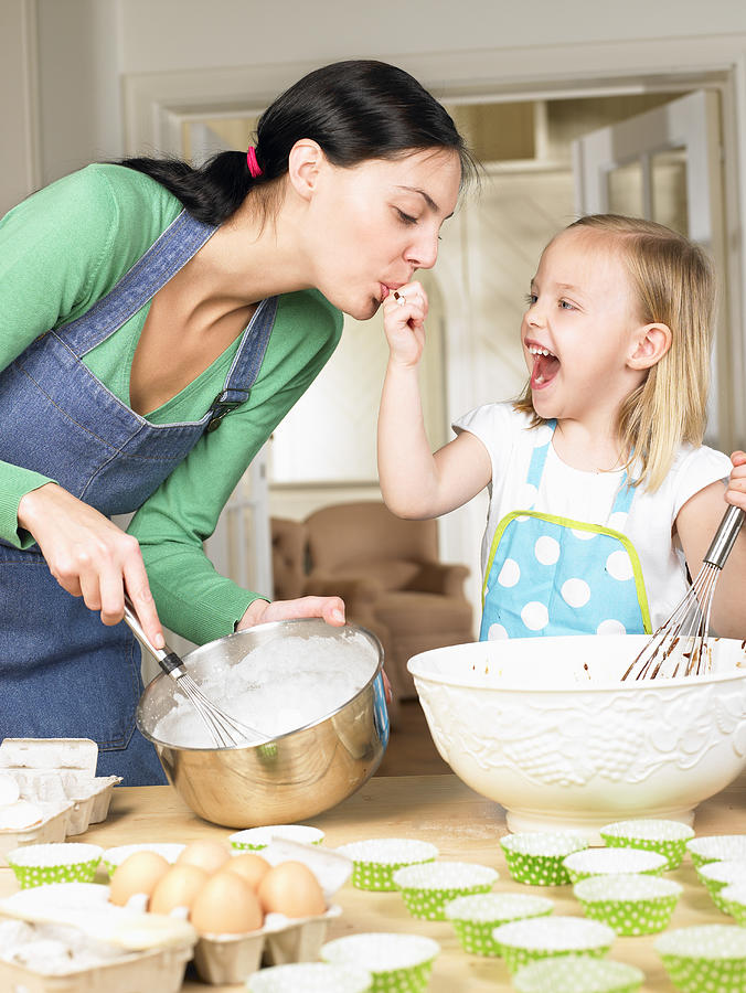 Mother and daughter cooking Photograph by Ghislain & Marie David de Lossy
