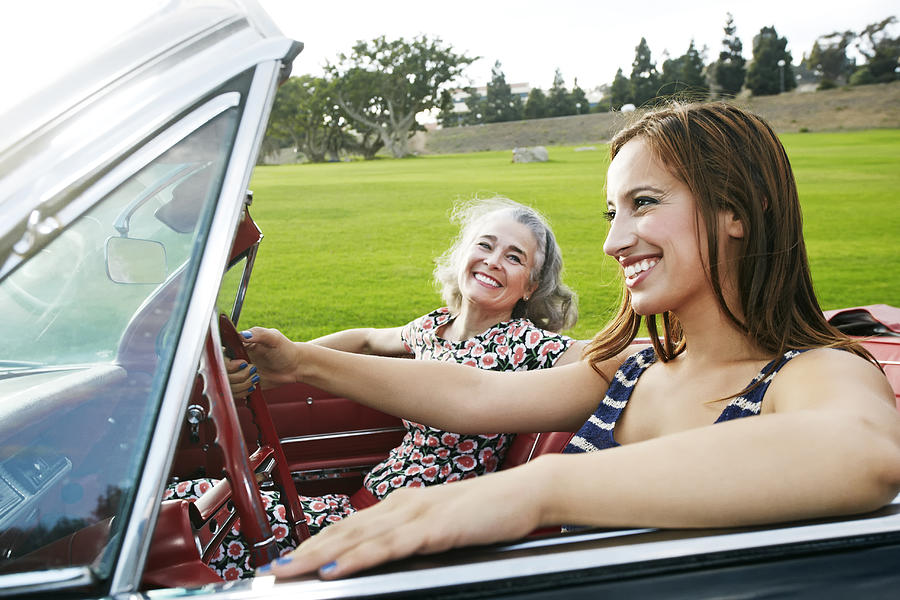 Mother and daughter driving in classic convertible #1 Photograph by Peathegee Inc