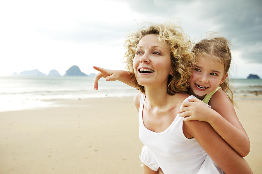 Mother and daughter having fun on beach #1 Photograph by Bolot
