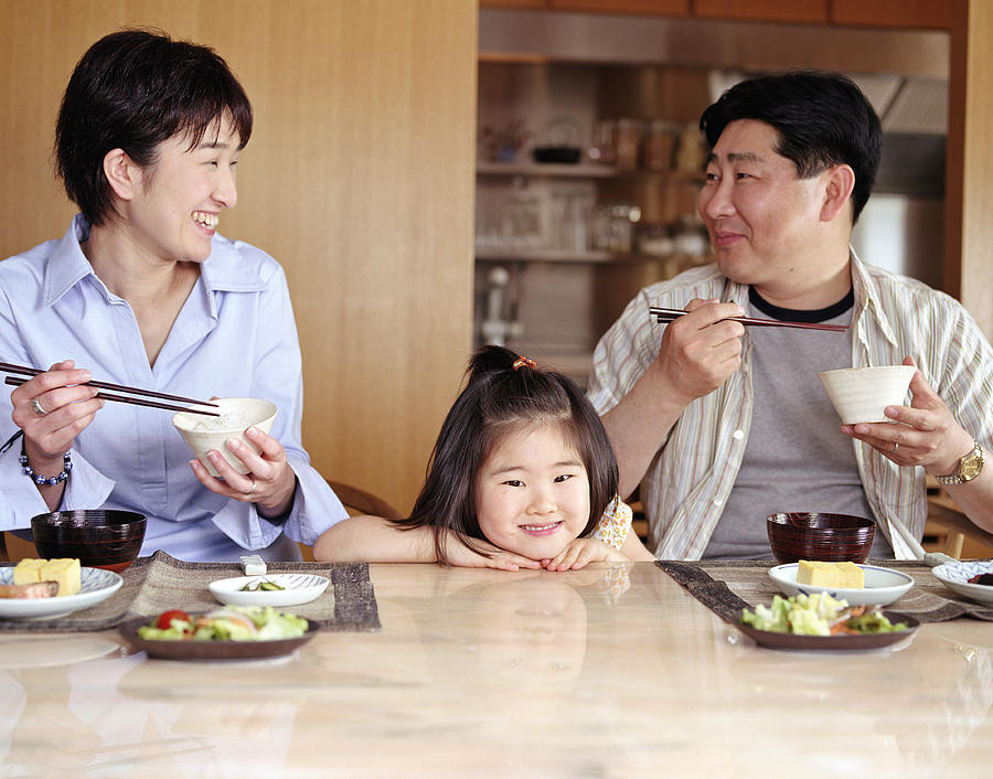 Mother, father and daughter (2-4) eating meal at home #1 Photograph by Ryan McVay
