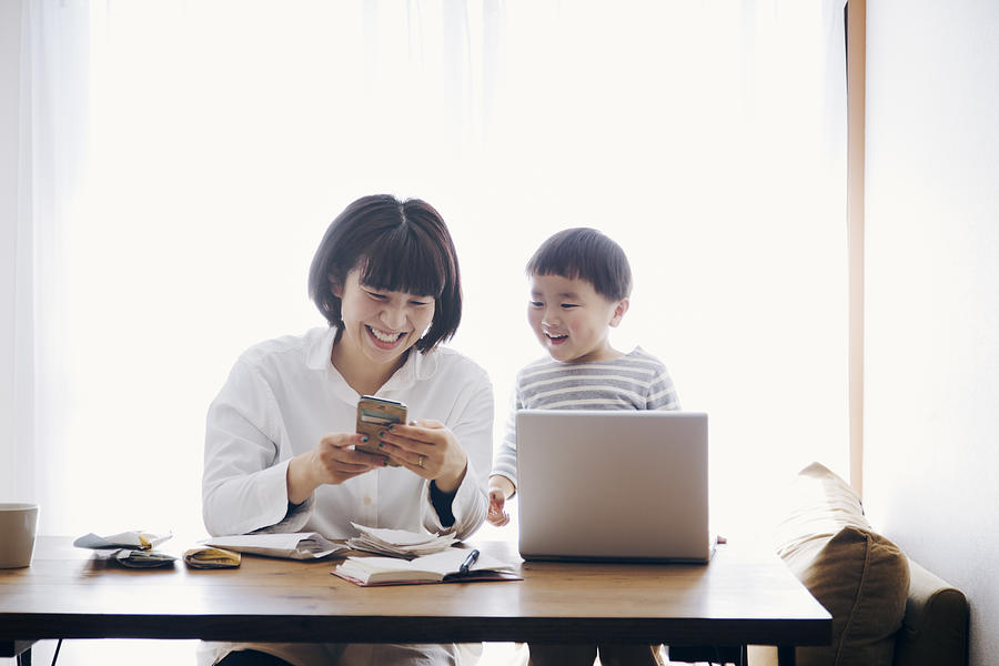 Mother with son working at home #1 Photograph by Kohei_hara