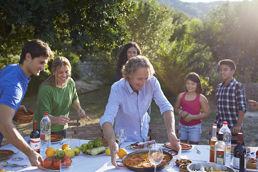 Multigenerational family setting dinner table #1 Photograph by Klaus Vedfelt