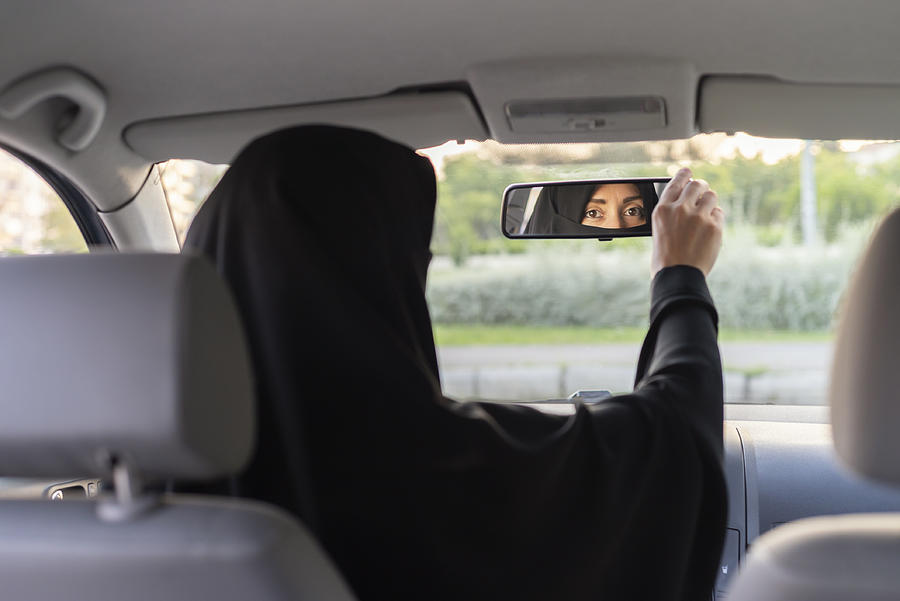 Muslim woman driving a car #1 Photograph by Brightstars