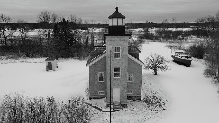 Ontonagon Michigan Lighthouse along Lake Superior in winter in black and white #1 Photograph by Eldon McGraw