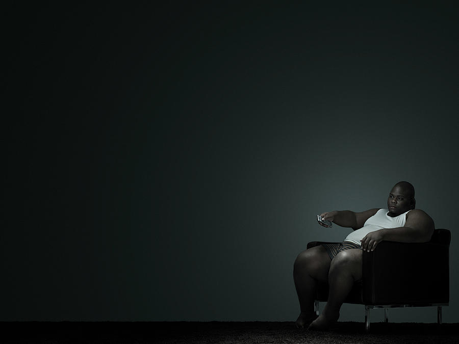 Overweight man watching television #1 Photograph by Image Source