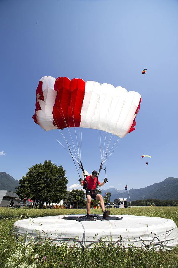 Parachutist performing an accuracy landing #1 Photograph by Oliver Furrer