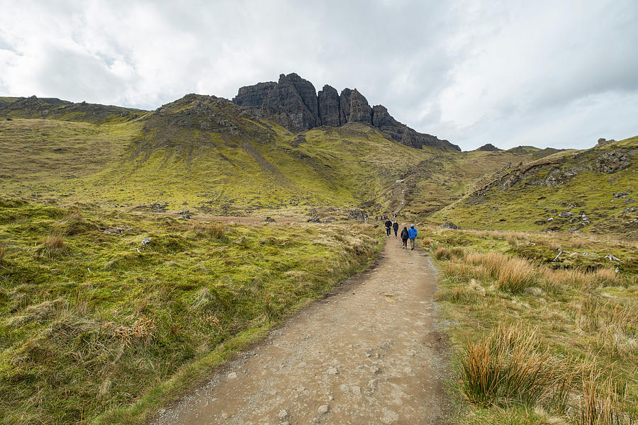 People walking on popular hiking trail at the Storr rock formati #1 Photograph by David L Moore