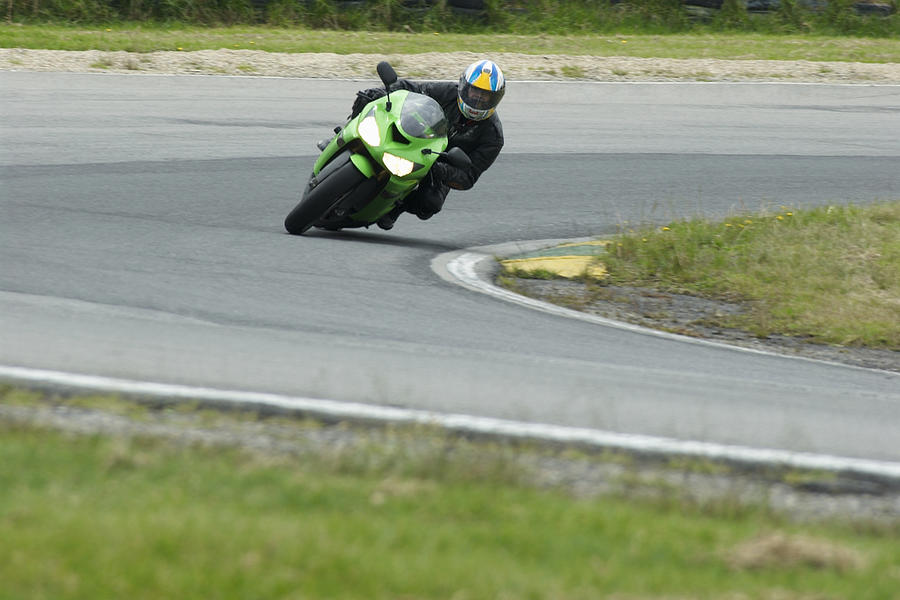 Person riding a motorcycle on a motor racing track #1 Photograph by Glowimages
