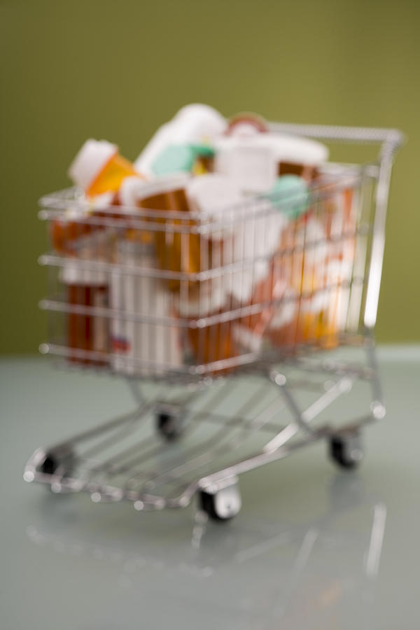 Pill bottles in shopping cart #1 Photograph by Comstock Images