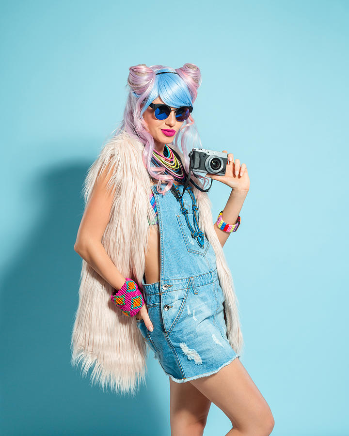 Pink hair girl in funky manga outfit holding camera #1 Photograph by Izusek