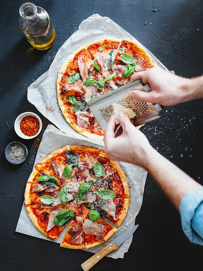 Pizza with prosciutto, basil and parmesan cheese #1 Photograph by Eugene Mymrin