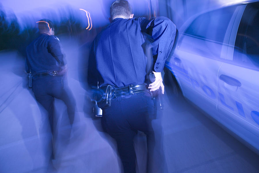 Police officers running #1 Photograph by Thinkstock Images
