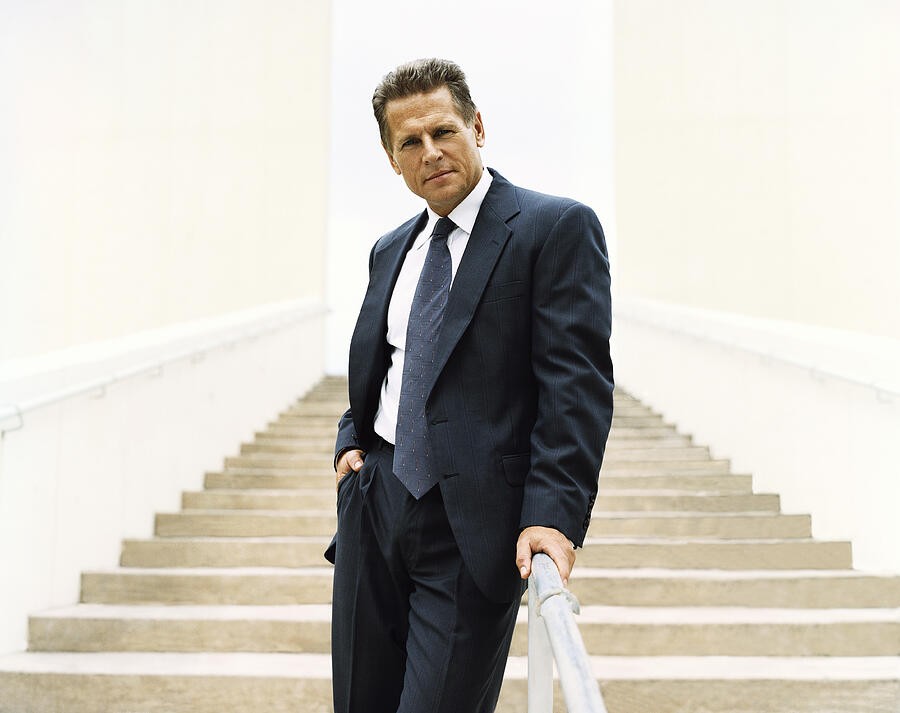 Portrait of a Mature Businessman Standing at the Bottom of Steps #1 Photograph by Digital Vision.