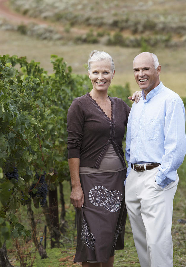 Portrait of a Senior Couple Standing in a Vineyard #1 Photograph by John Cumming