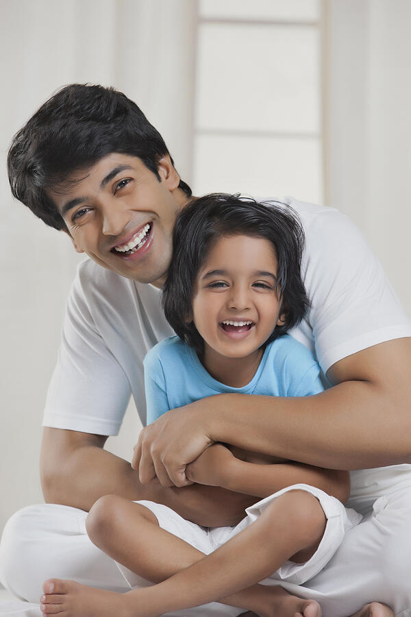 Portrait of father and son smiling #1 Photograph by IndiaPix/IndiaPicture