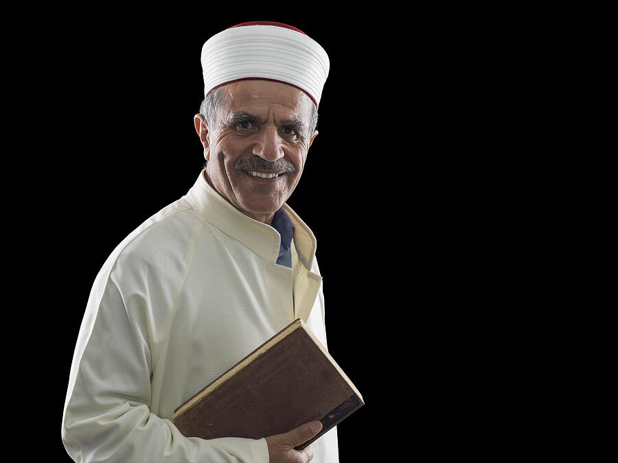 Portrait of muslim imam holding Koran #1 Photograph by Mehmet Selim Aksan
