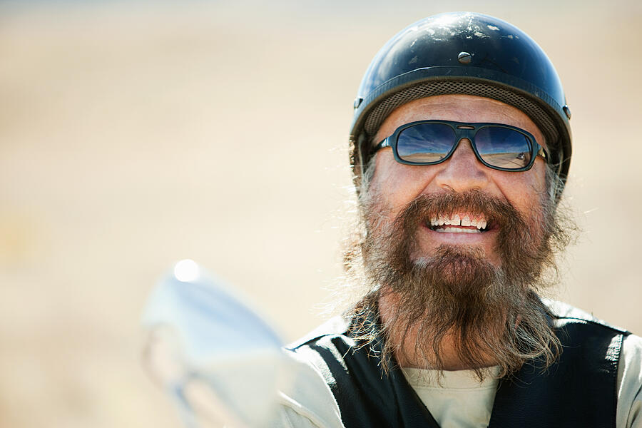 Portrait of senior motorcyclist laughing #1 Photograph by Image Source