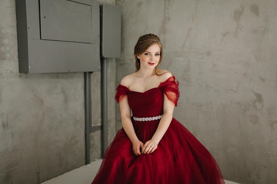 Portrait of woman in  red prom dress  in studio #1 Photograph by Igor Ustynskyy