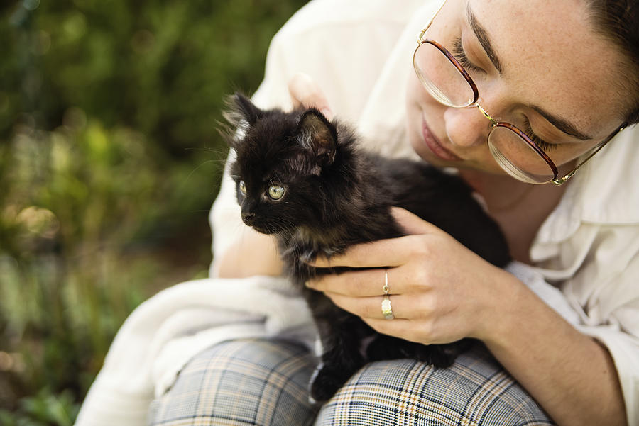 Portrait of young woman with newly adopted kitten. #1 Photograph by Martinedoucet
