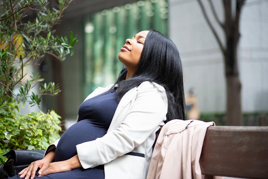 Pregnant woman sitting outside #1 Photograph by Electravk