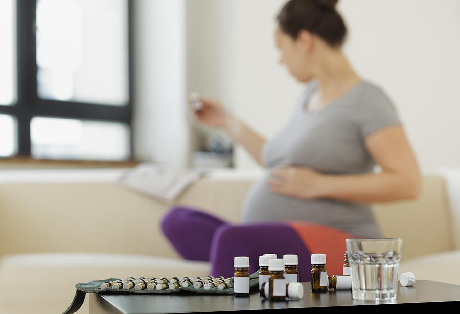 Pregnant Woman with Homeopathic Pills #1 Photograph by Thomas_EyeDesign
