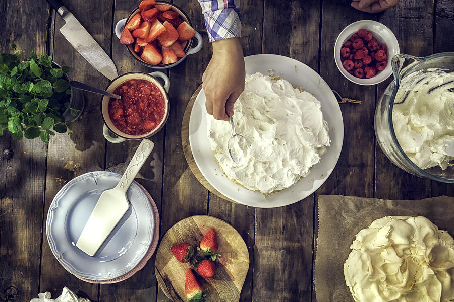 Preparing Berry Pavlova Cake with Strawberries and Raspberries #1 Photograph by GMVozd