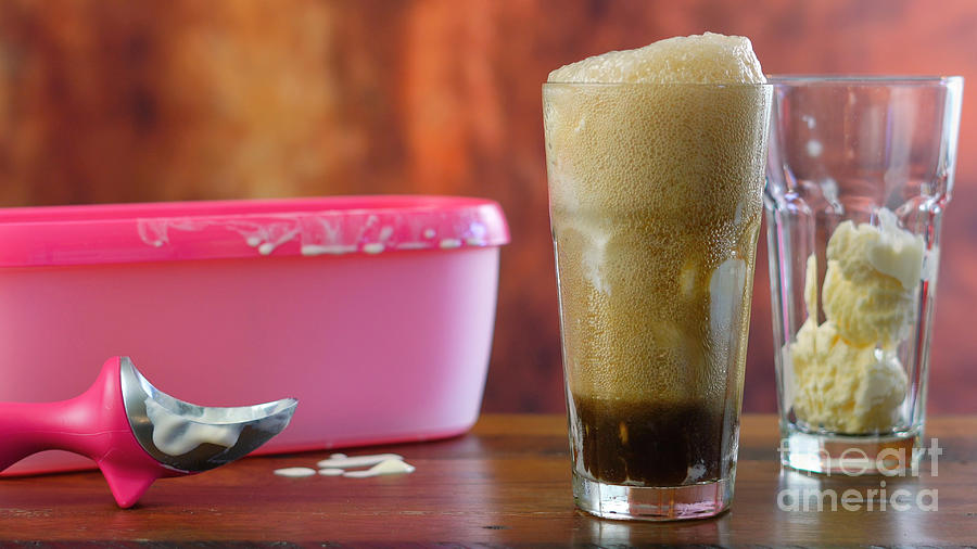 Preparing black cow cola ice cream soda floats #1 Photograph by Milleflore Images