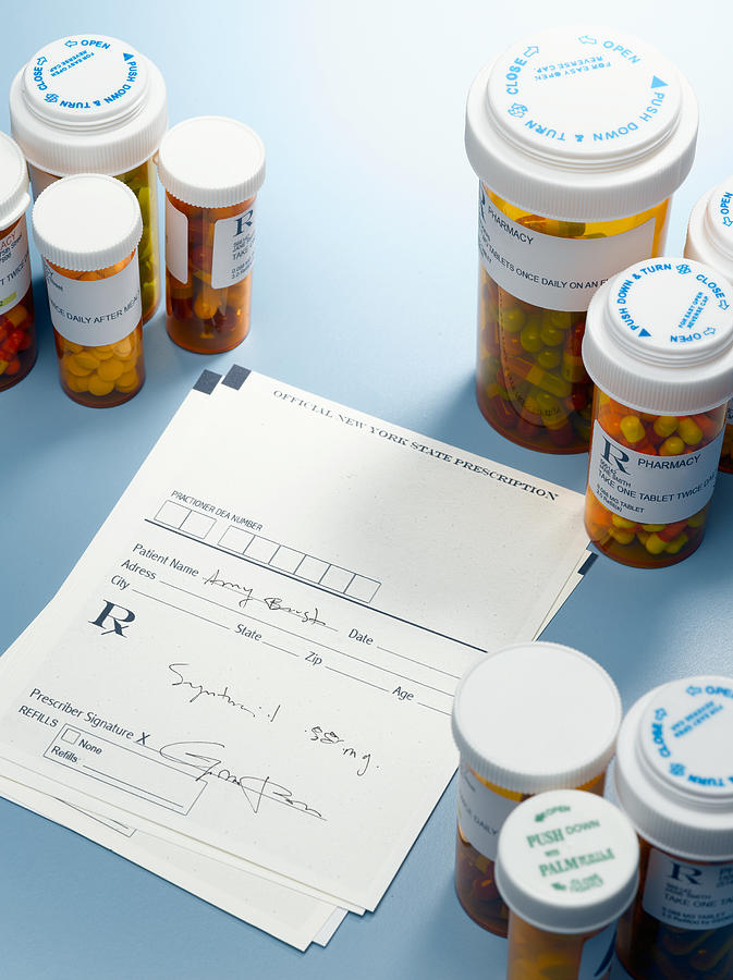 Prescription slip and pill bottles #1 Photograph by Jeffrey Hamilton
