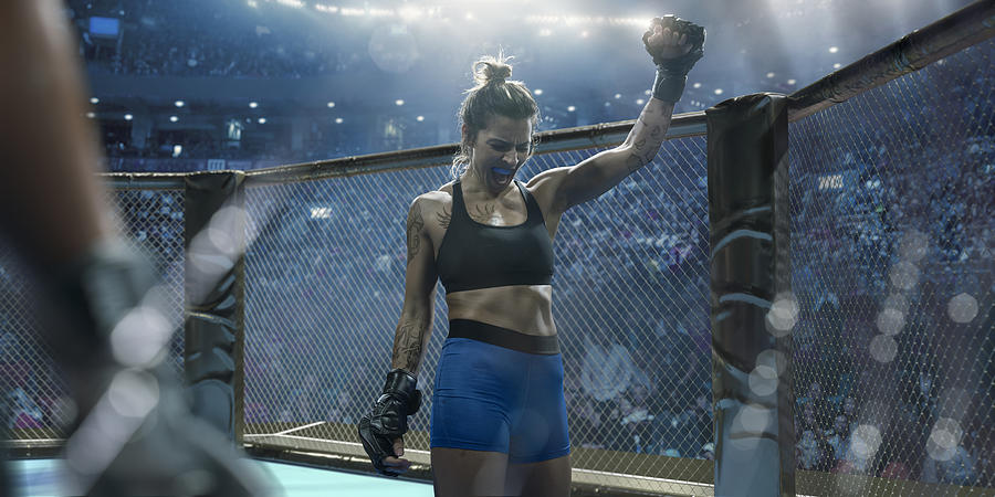 Professional Female Mixed Martial Arts Fighter Raising Fist In Victory #1 Photograph by Peepo