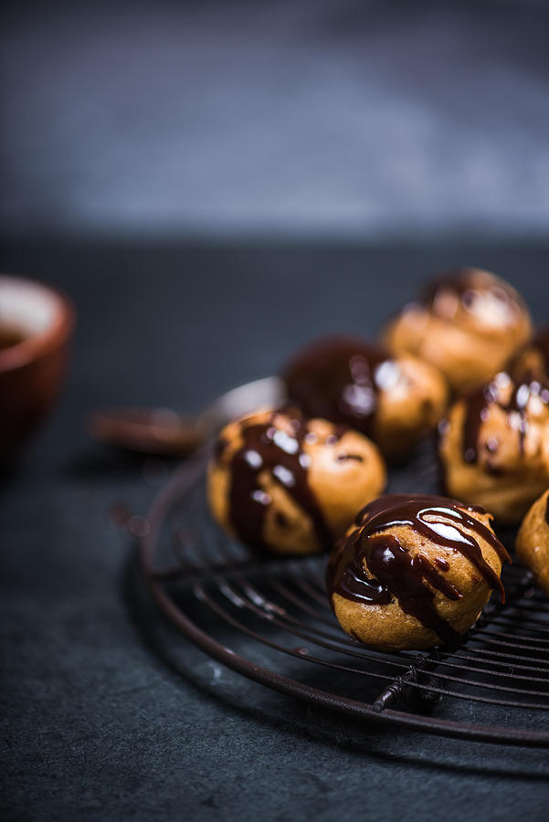 Profiteroles Eclairs Resting On Cooling Rack #1 Photograph by Merc67
