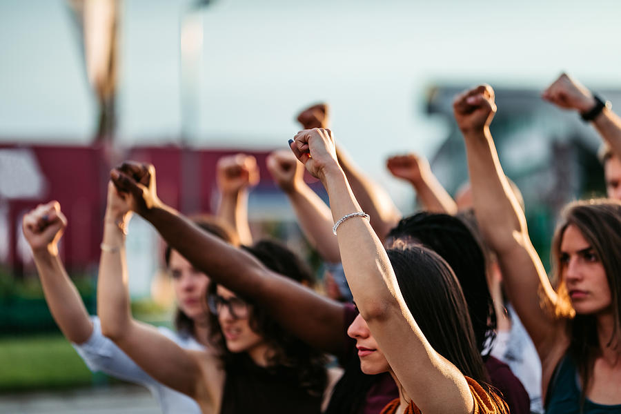 Protestors raising fists #1 Photograph by Urbazon
