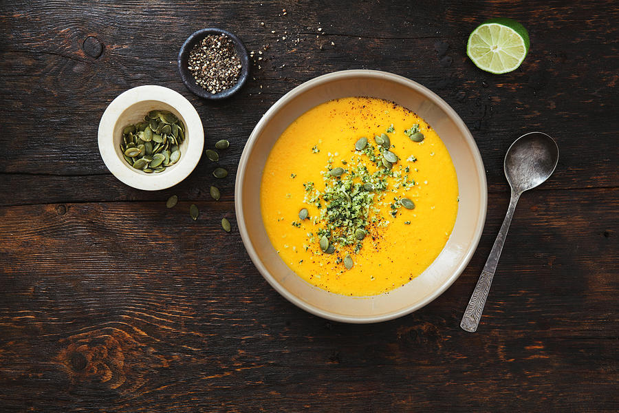 Pumpkin soup with coconut and seeds #1 Photograph by Eugene Mymrin