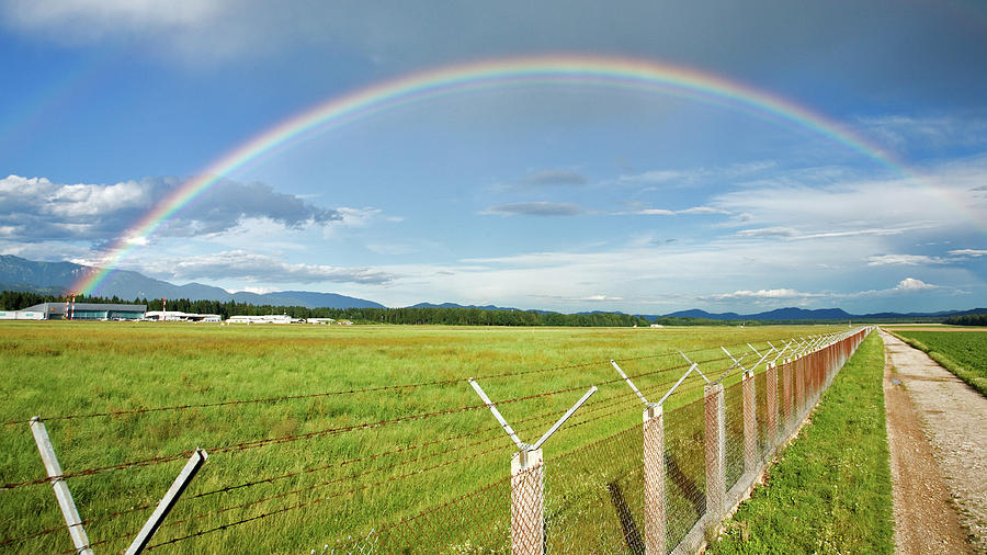 Rainbow over Ljubljana Joze Pucnik Airport, Slovenia. #1 Photograph by Ian Middleton
