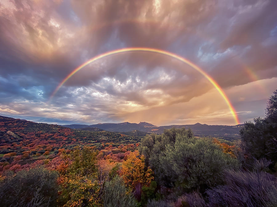 Rainbow over Regino Valley #1 Photograph by Jon Ingall