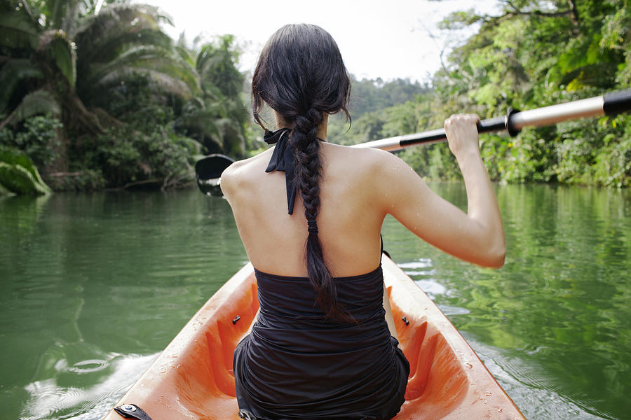 Rear view of woman kayaking on lake at forest #1 Photograph by Cavan Images