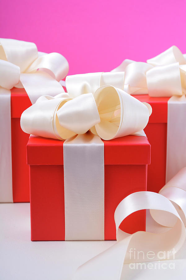 Red and white gifts on pink background.  #1 Photograph by Milleflore Images
