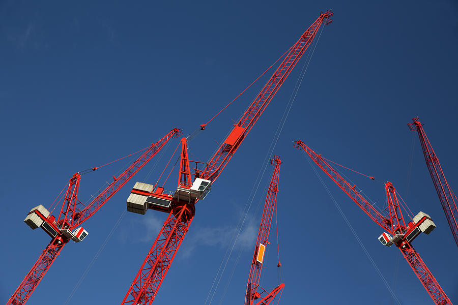 Red construction cranes #1 Photograph by Russ Rohde