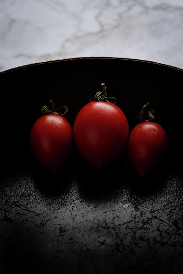 Red Fresh Healthy Tomatoes Isolated On A Black Pan Photograph