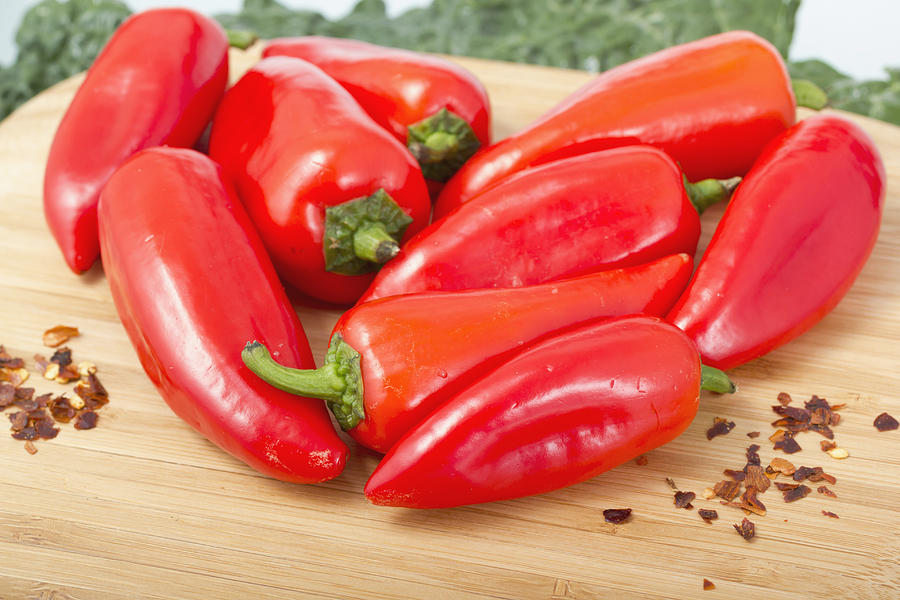 Red hot peppers on wooden cutting board. #1 Photograph by Snyferok
