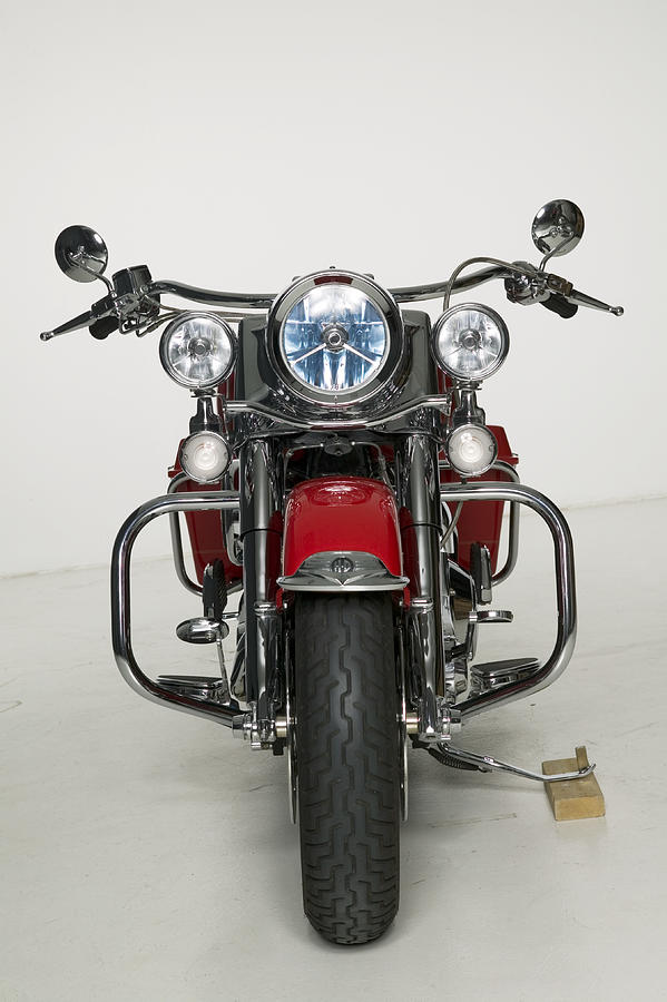 Red motorcycle parked in studio #1 Photograph by Photodisc
