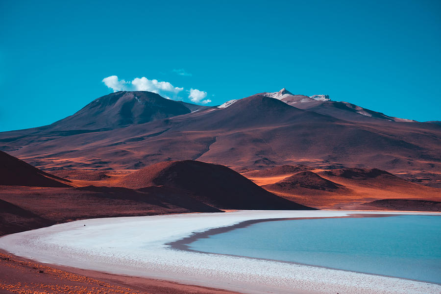 Red volcanic mountains and a blue salt lake. Beautiful nature background #1 Photograph by by Tatsiana Volskaya