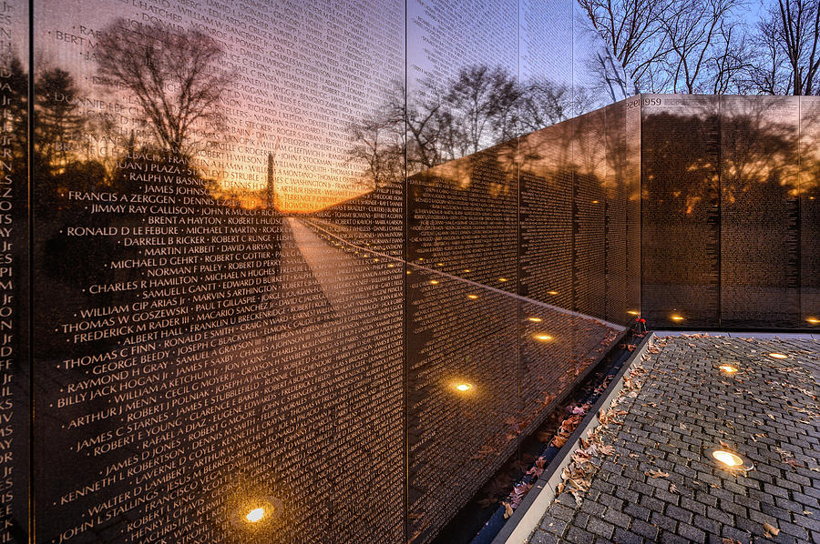 Sunrise reflections at the Vietnam Veterans Memorial Photograph by Robert Miller