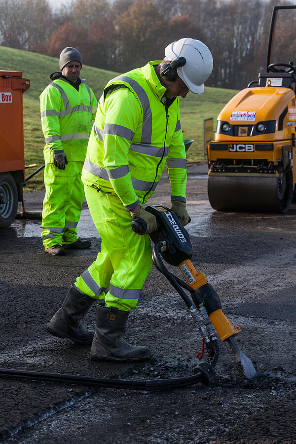 Roadworker using pneumatic drill or Jack Hammer. #1 Photograph by Wcjohnston