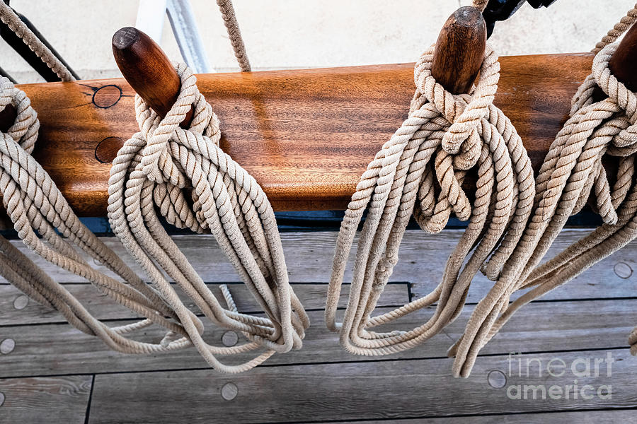Ropes on a sailboat to tighten the sails of the ship during a cruise for tourists. #1 Photograph by Joaquin Corbalan
