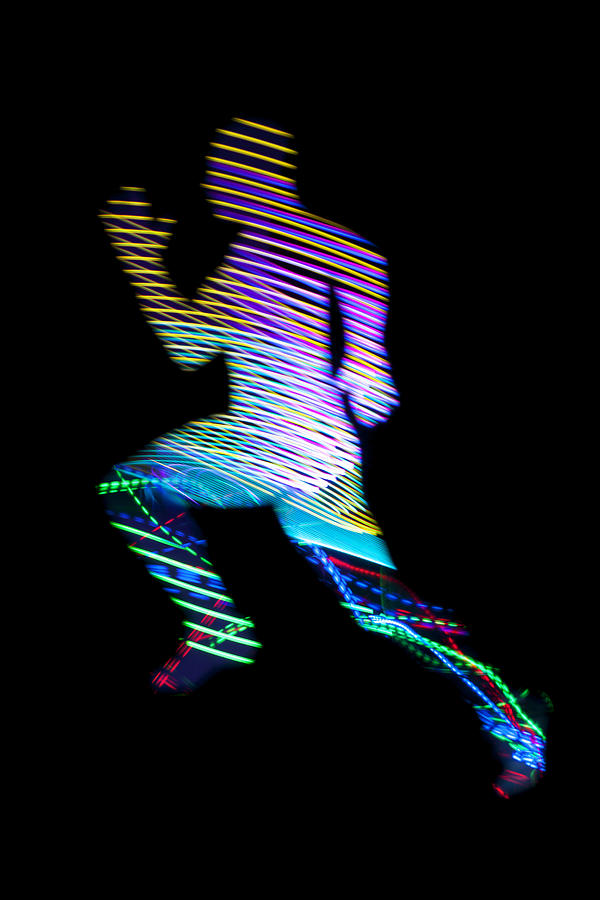 Running man with light trail texture on black #1 Photograph by Colormos