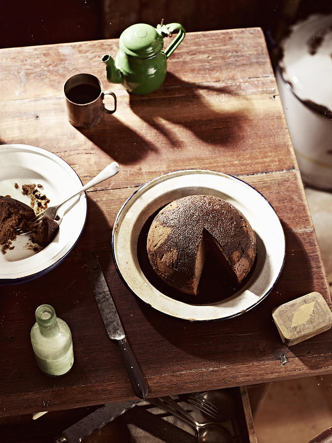 Rustic table with dish of steamed treacle pudding and teapot #1 Photograph by Brett Stevens