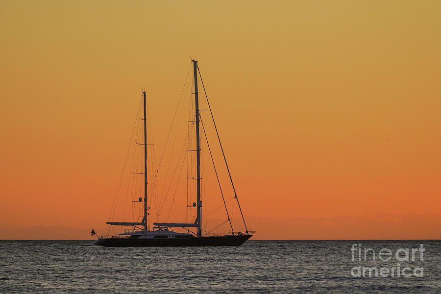 Sail boat sailing near the coast with mediterranean sunset. #1 Photograph by Perry Van Munster