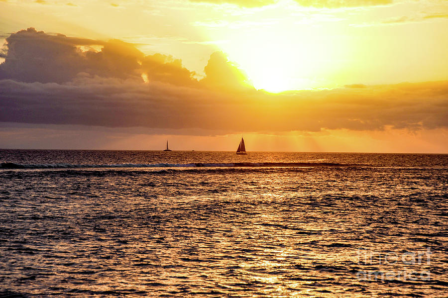 Sailboat silhouette in the setting sun over the ocean on the island of Maui, Hawaii. #1 Photograph by Gunther Allen